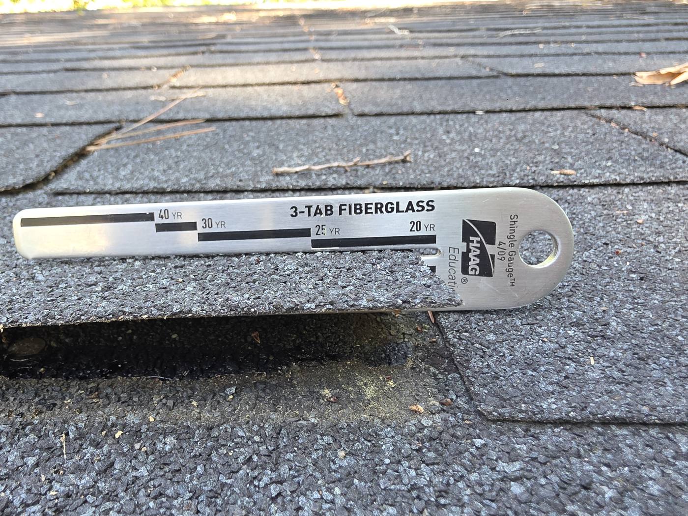 Haag Shingle Gauge measuring 3-tab fiberglass shingles during repairability assessment